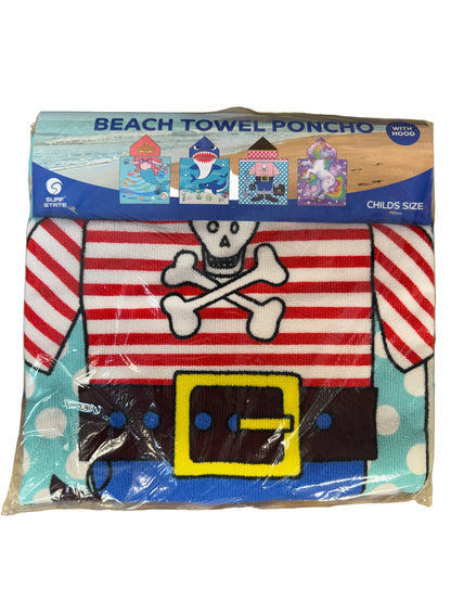 Pirate-themed beach towel poncho with packaging on a wooden surface
