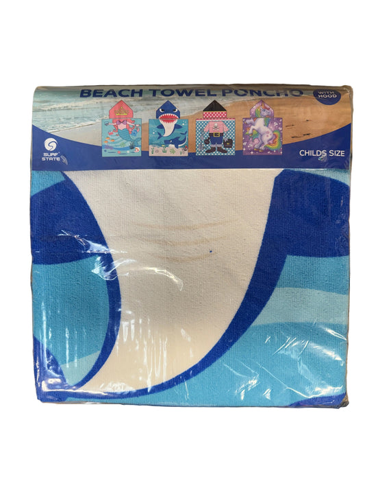 Packaged beach towel with blue and white design on a wooden surface